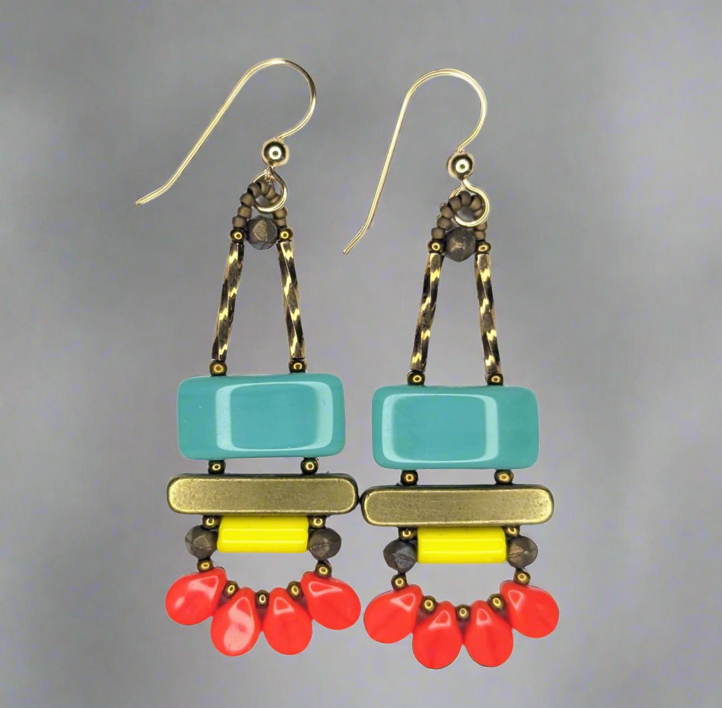 Long brightly colored earrings against a soft gray background. The earrings each have a wide turquoise rectangle stacked on top of a brass colored bar. Under the bar there is a yellow tube and a swag of four warm red petal beads.